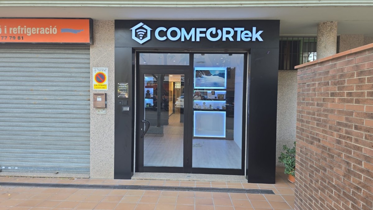 Fachada de Comfortek en Lloret de Mar, de día: entrada y escaparate del local
